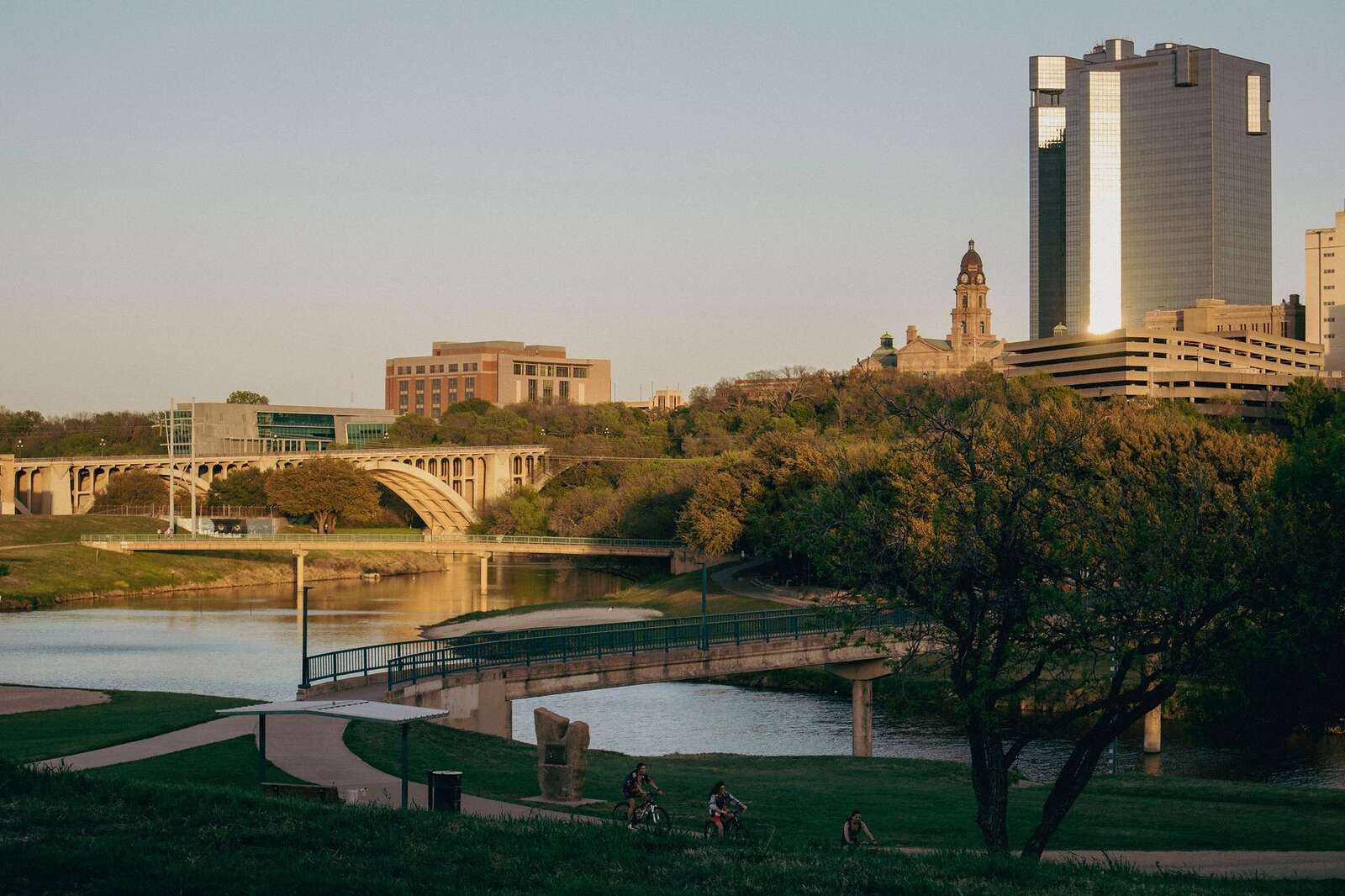 The downtown Fort Worth skyline and a bridge over the Trinity River at sunset