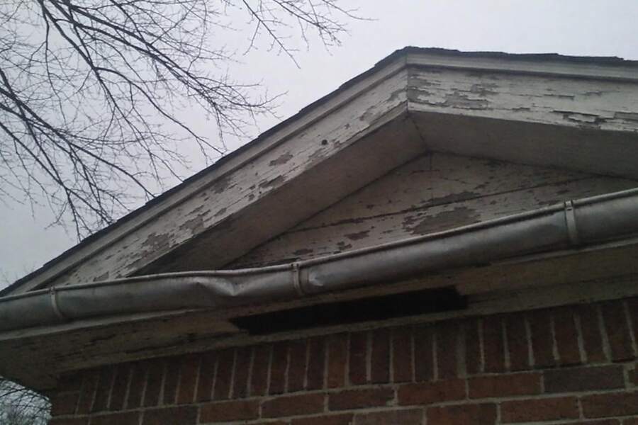 The gable and eave of an older house seen from below